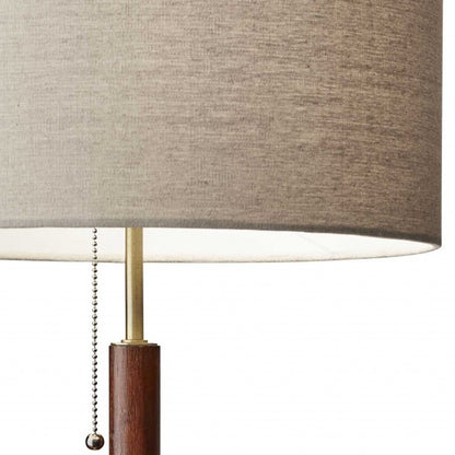 26" Antiqued Brass Solid Wood Table Lamp With Beige Drum Shade