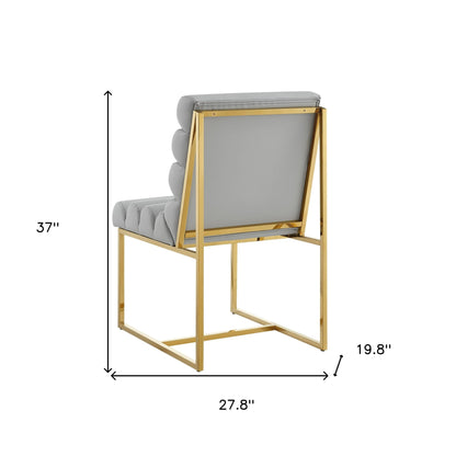 Ensemble de deux chaises de salle à manger capitonnées en similicuir gris et doré